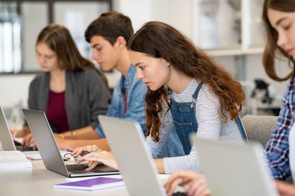 Female Student Working On Laptop