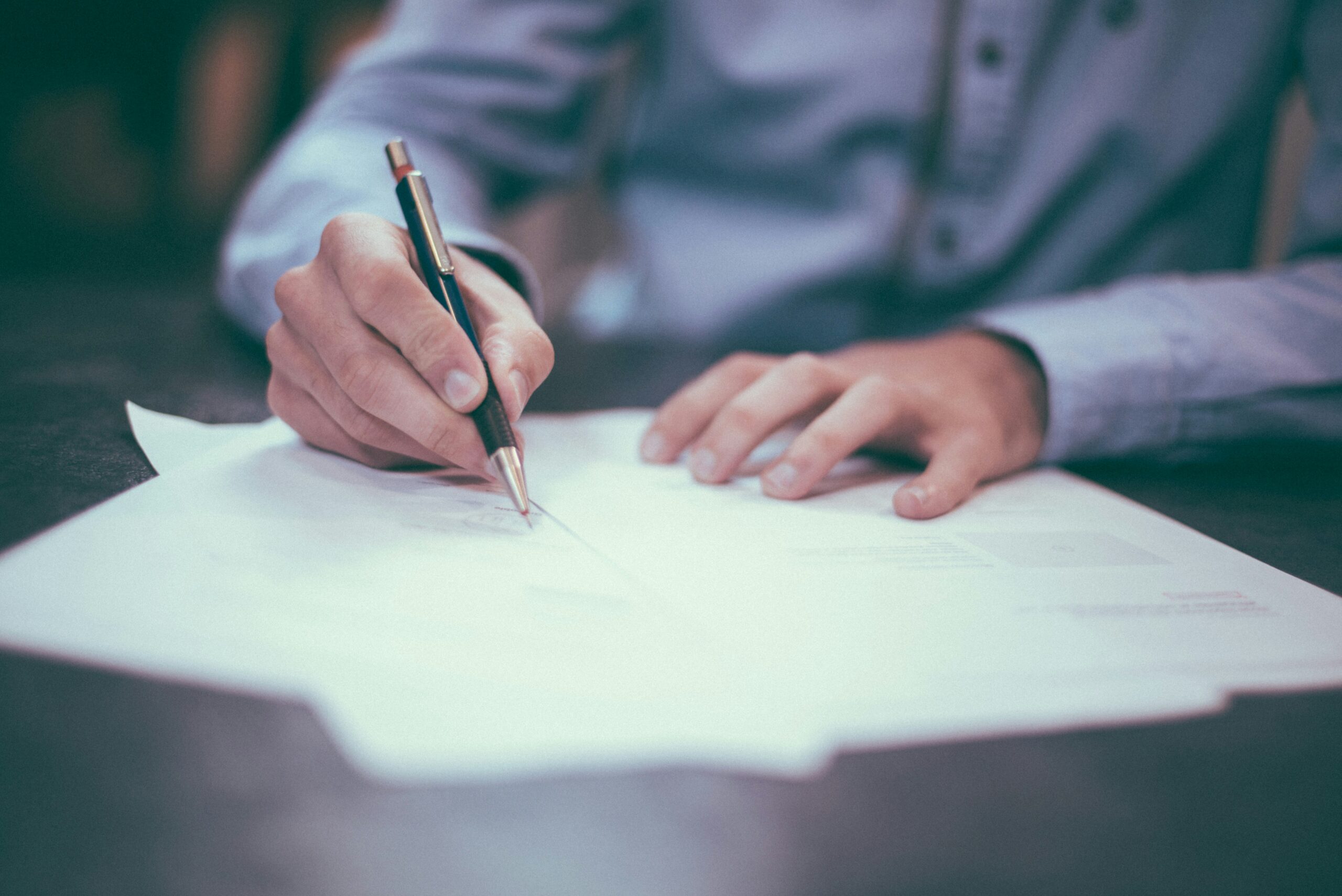 A person writing on a document