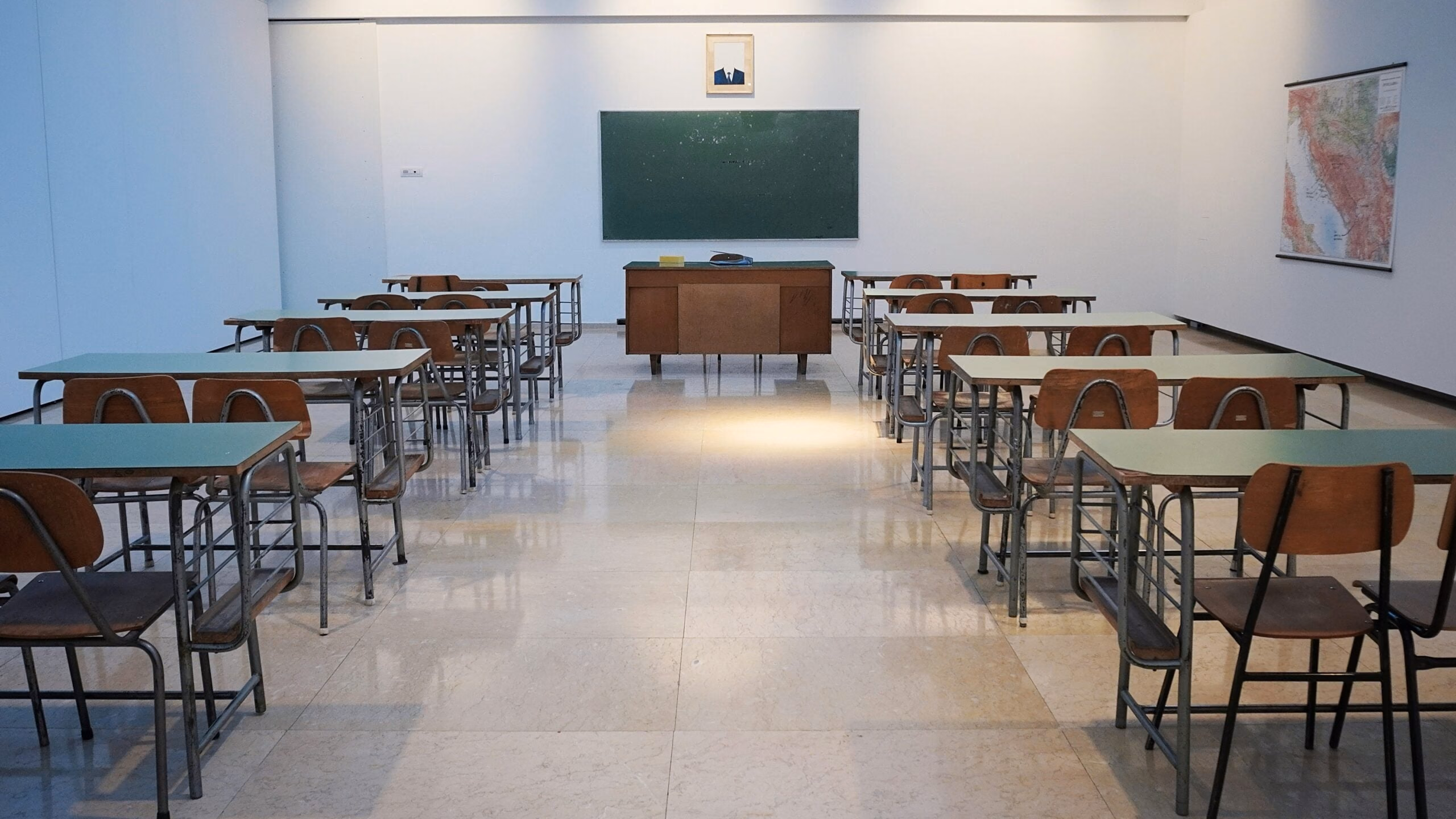 An empty classroom with a TV on the wall